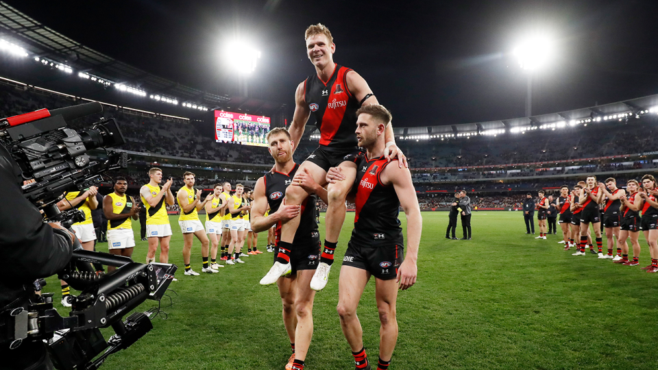 Michael Hurley is chaired off the ground by teammates Dyson Heppell and Jayden Laverde after scoring his goal. (Getty Images)