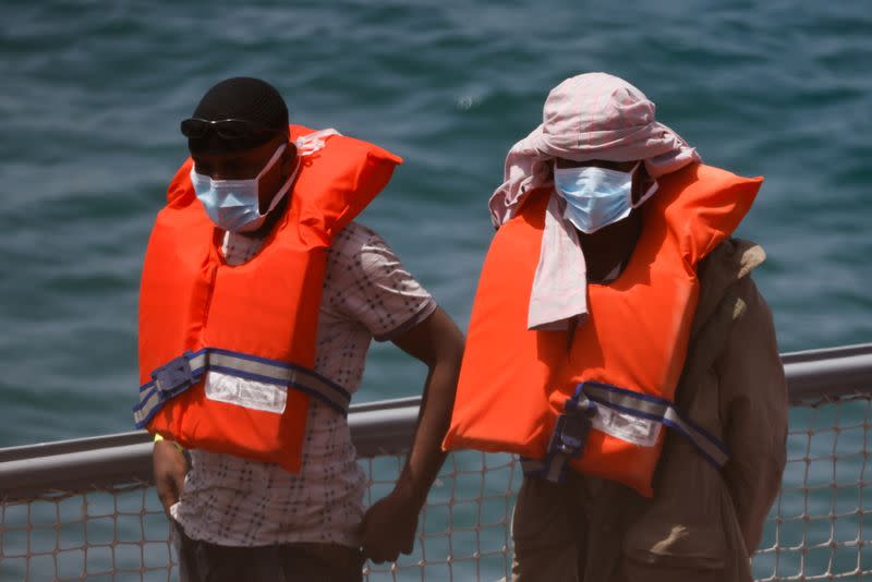 Rescued migrants disembark from an Armed Forces of Malta vessel in Senglea, in Valletta's Grand Harbour