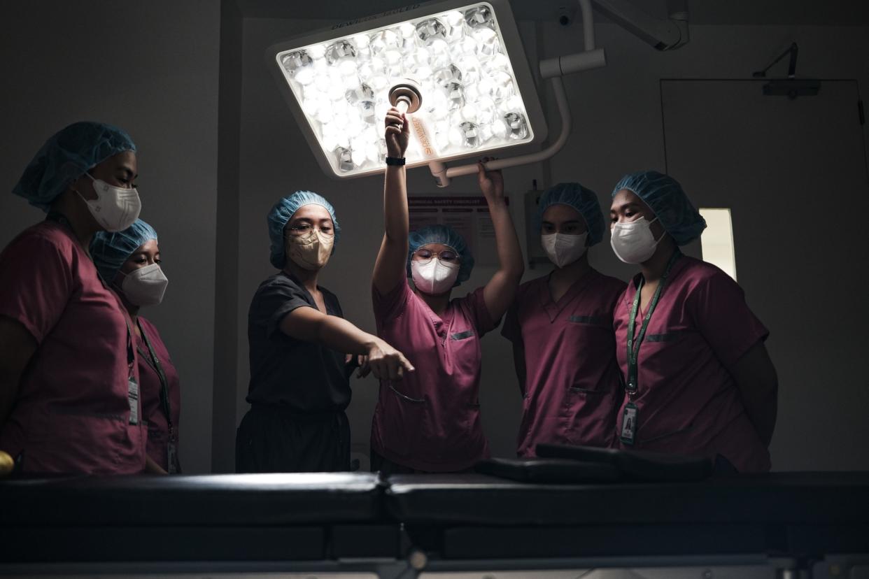 Nursing students during a demonstration inside an operating room at the Asian Breast Center in Makati City, in Manila.