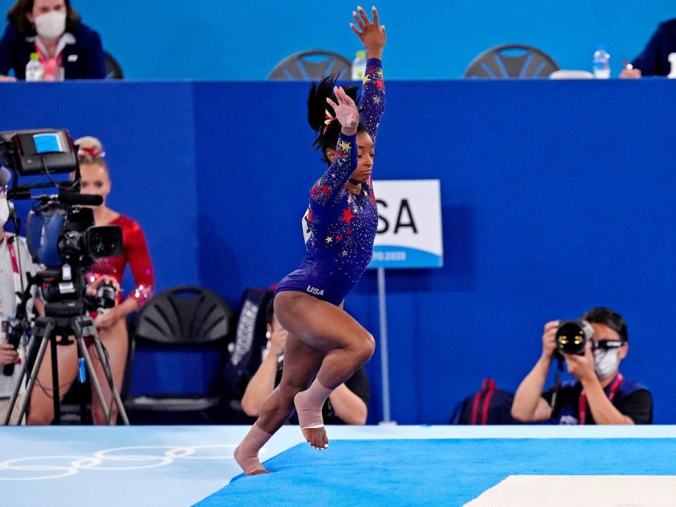 Simone Biles steps off the mat during her floor routine.