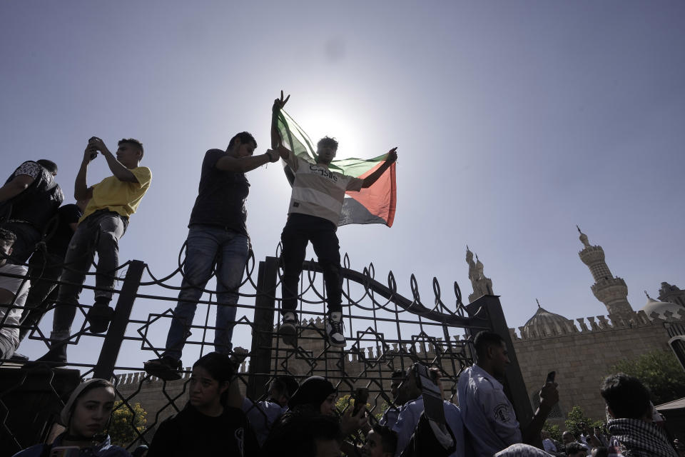 A protester holds a Palestinian flag during a rally to show solidarity with the people of Gaza after Friday prayers outside Azhar mosque, the Sunni Muslim world's premier Islamic institution, in Cairo, Egypt, Friday, Oct. 20, 2023. (AP Photo/Amr Nabil)