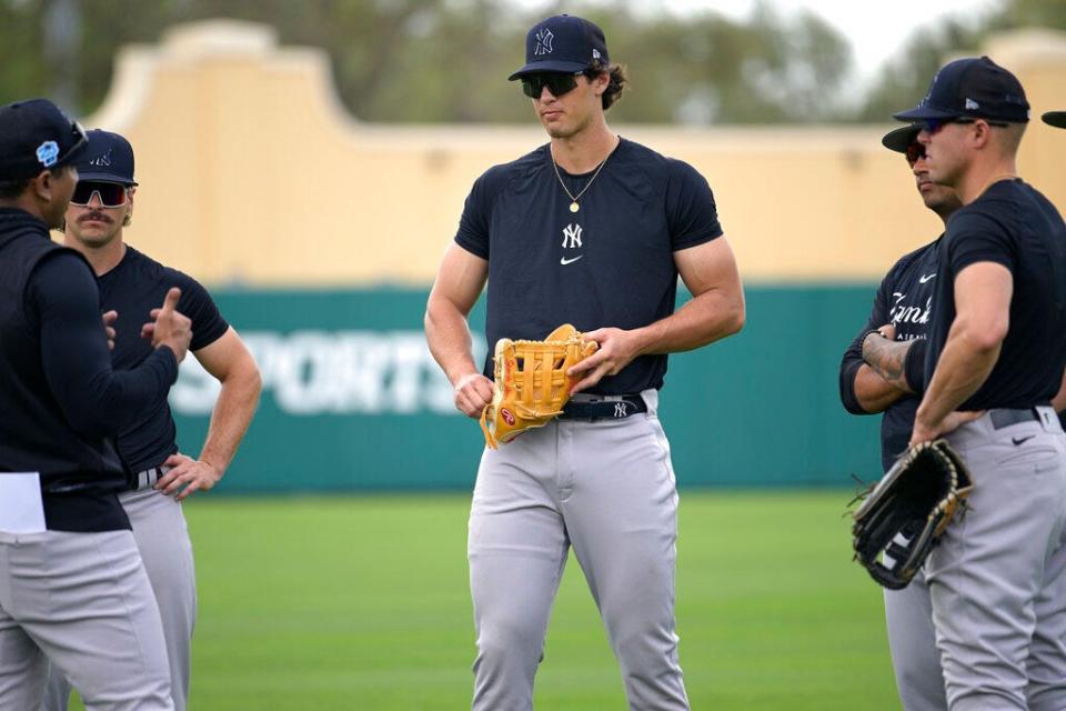 New York Yankees outfielder Spencer Jones, center, listens during a meeting on the field before a spring training baseball game against the Tampa Bay Rays, Tuesday, Feb. 28, 2023, in Kissimmee, Fla. (AP Photo/Phelan M. Ebenhack)