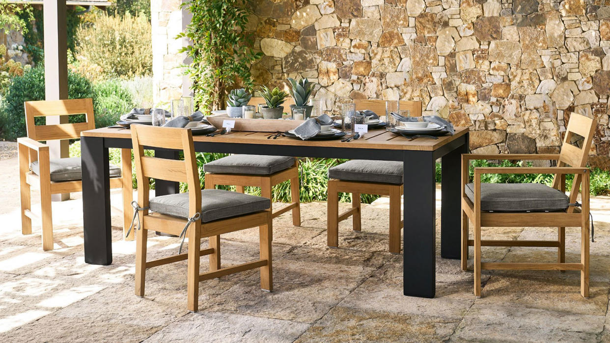  outdoor dining area underneath a pergola 