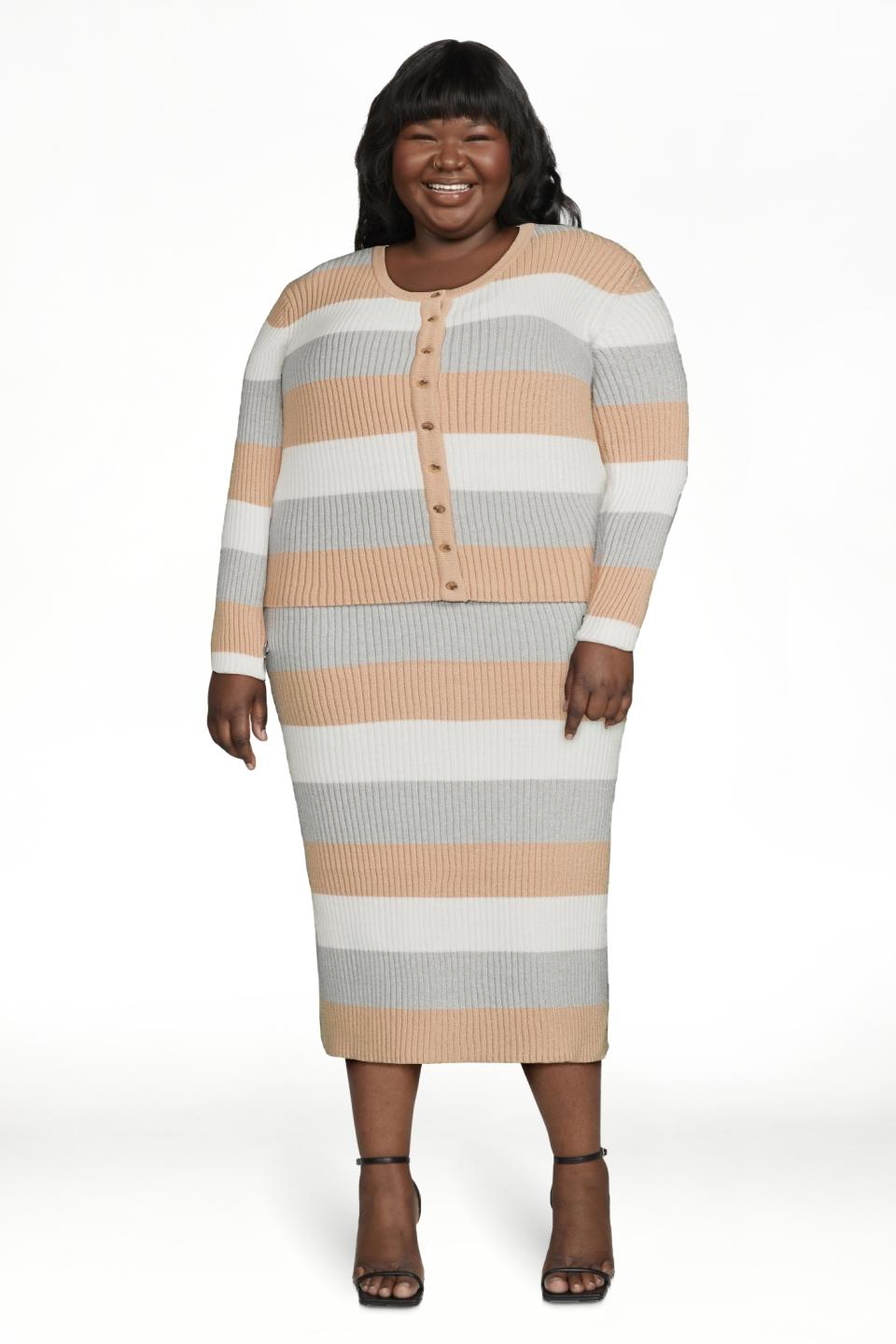 Model in a striped button-up dress and heeled sandals, smiling, with a white background. Ideal for a casual outing