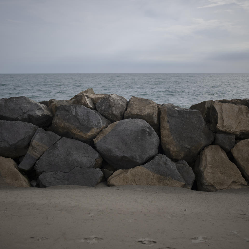 A dike built to hold back the sea from advancing into Raynaud's pasture is pictured in Camargue, southern France, Sept. 23, 2022. The dike was created by local authorities as a temporary solution but is pushed farther back each year. "It is impossible to stop the sea, maybe we can slow down its rise, but we cannot stop it. It does what it wants," said Frederic Raynaud. (AP Photo/Daniel Cole)