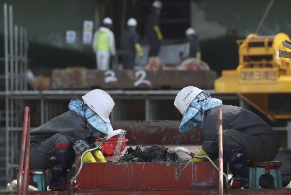 Workers pick through wreckage of the salvaged ferry in 2017. Photo: AAP