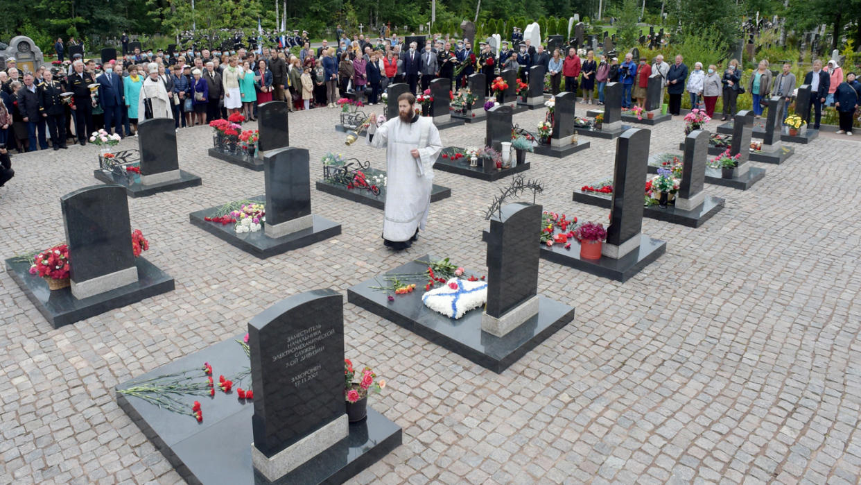 A priest leads a service during a memorial ceremony for those who died in the Kursk submarine disaster 