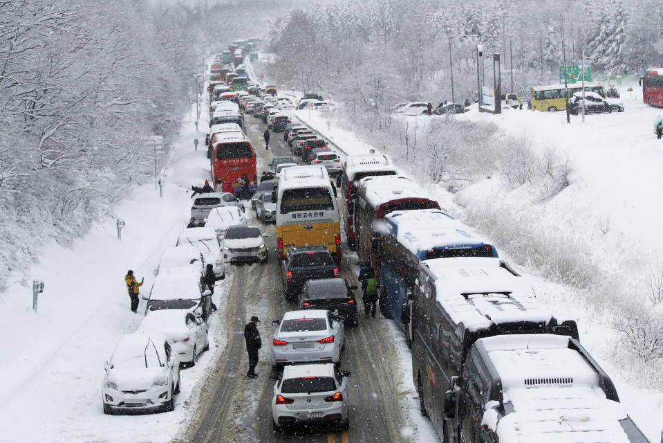 ADDS MORE DETAILS TO CLARIFY THIS TRAFFIC CONGESTION DIFFERS FROM THE ACCIDENT THAT OCCURRED NEAR SEOUL - Vehicles are stuck on a highway in heavy snow in Pyeongchang, about 126 kilometers (78 miles) east of Seoul, South Korea, Sunday, Jan. 15, 2023. Elsewhere, on the Guri-Pocheon highway near the South Korean capital Sunday night, nearly 50 vehicles collided on an icy highway, killing at least one person and injuring dozens. (Yoo Hyung-je/Yonhap via AP)