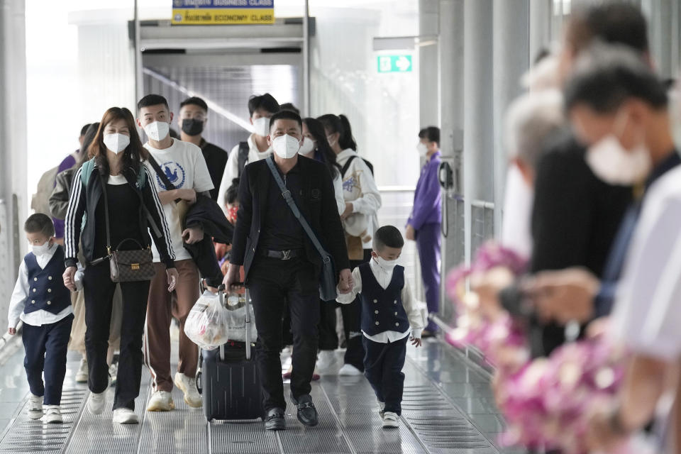 Chinese tourists arrive at Suvarnabhumi International Airport in Samut Prakarn province, Thailand, Monday, Jan. 9, 2023. Thailand is looking forward to hosting large numbers of visitors from China again after Beijing eased travel restrictions on Sunday. Chinese were about one-third of the total number of tourists visiting Thailand before the coronavirus pandemic, and the authorities hope they can help its lucrative tourism industry recover. (AP Photo/Sakchai Lalit)