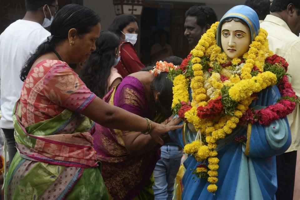 Catholics offer prayers in front of a statue of Virgin Mary in Hyderabad, India. <a href="https://www.gettyimages.com/detail/news-photo/catholic-devotees-offer-prayers-in-front-of-a-statue-of-news-photo/1243033358?adppopup=true" rel="nofollow noopener" target="_blank" data-ylk="slk:Noah Seelam/AFP via Getty Images;elm:context_link;itc:0;sec:content-canvas" class="link ">Noah Seelam/AFP via Getty Images</a>
