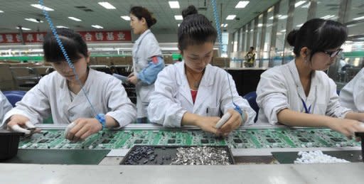 Chinese workers assemble circuit boards at a factory in Mianyang, southwest China's Sichuan province in April 2012. China's manufacturing activity grew at a markedly lower rate in May, official data showed Friday, providing further confirmation that the world's number two economy is slowing rapidly