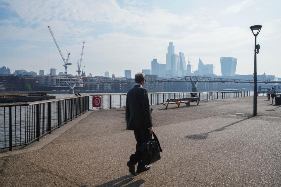 UK economy: A pedestrian walking on a hot humid morning on on bankside, London