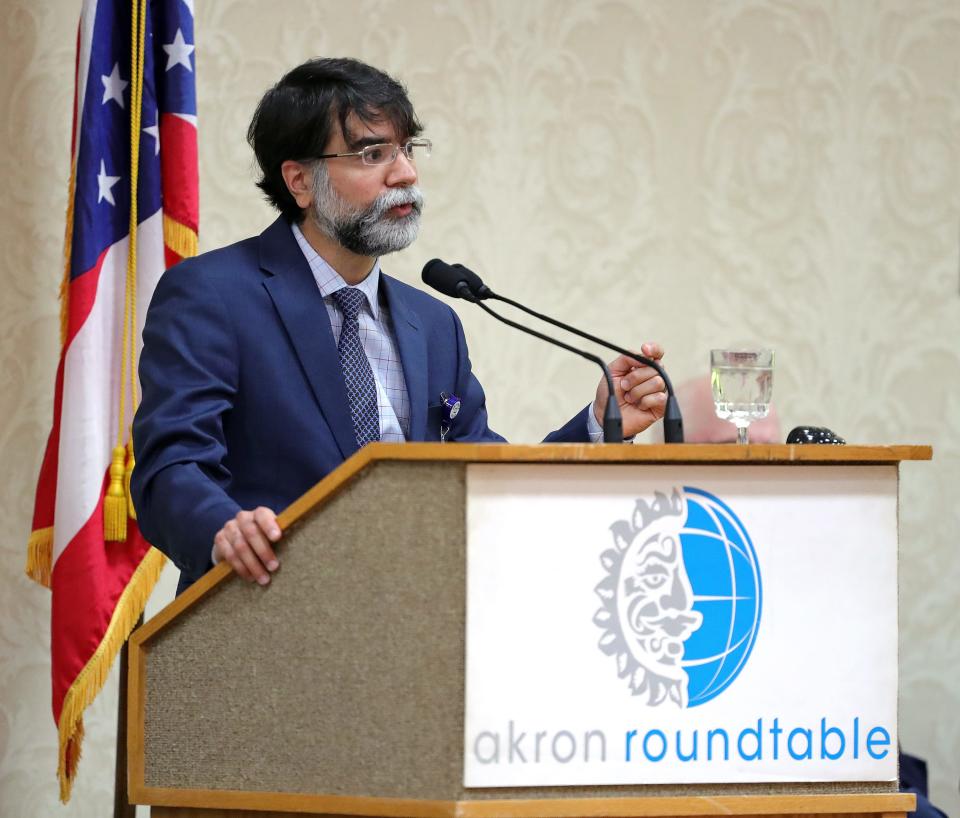 Dr. Daniel Vazquez, a trauma surgeon at Cleveland Clinic Akron General Hospital, delivers introductory remarks Thursday during an Akron Roundtable presentation on juvenile gun violence and crime.