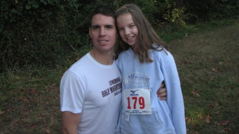 Bailey Donahue, age 11, poses with her dad’s race bib. Photo courtesy of the author.