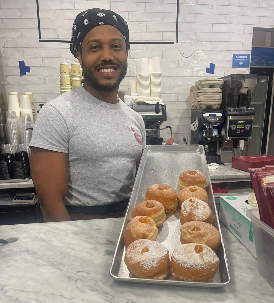 Willy Rincon displays apricot-filled powdered donuts at Dough in Rockefeller Center.