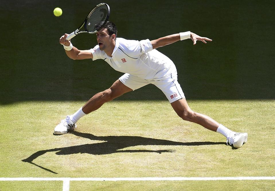 Novak Djokovic of Serbia hits a shot during his match against Richard Gasquet of France at the Wimbledon Tennis Championships in London, July 10, 2015. REUTERS/Andy Rain/Pool
