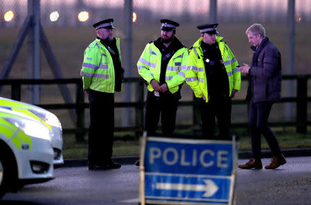 British police stand guard at the entrance to the US Air Force base at RAF Mildenhall, Suffolk, Britain December 18, 2017. REUTERS/Chris Radburn