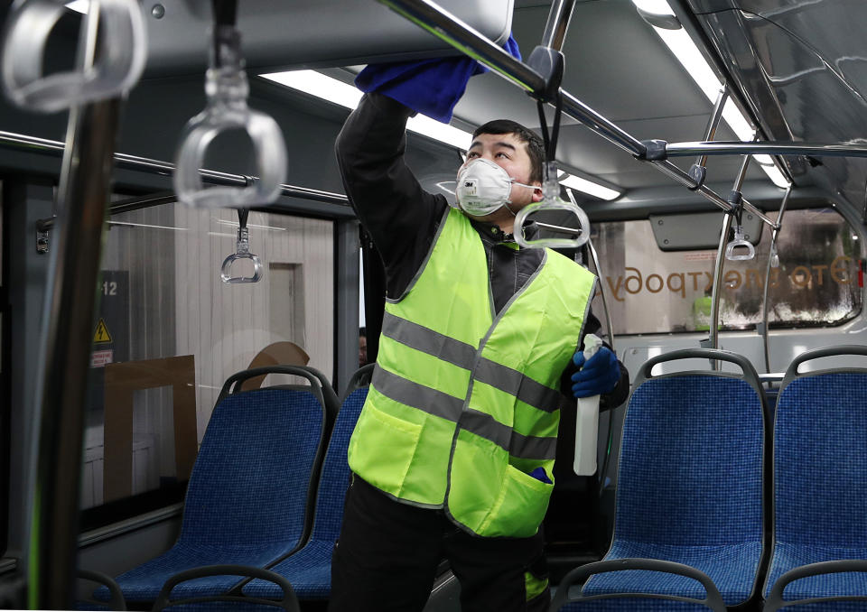 MOSCOW, RUSSIA - MARCH 3, 2020: An employee disinfecting an electric bus at Moscow's trolleybus depot No 6. Moscow's public transport ranks one of the cleanest and most sanitary in the world; both the bodies and the passenger compartments of buses, trams, electric buses and trolleybuses undergo wet cleaning every morning. Mikhail Tereshchenko/TASS (Photo by Mikhail Tereshchenko\TASS via Getty Images)