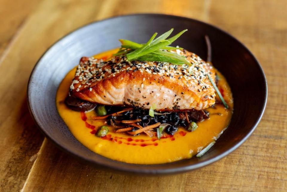 Forbidden salmon, a dish from the new fall menu at Nosh, has salmon, red curry coconut carrot puree, forbidden rice, edamame, shiitake, sprouts, sesame and scallions.