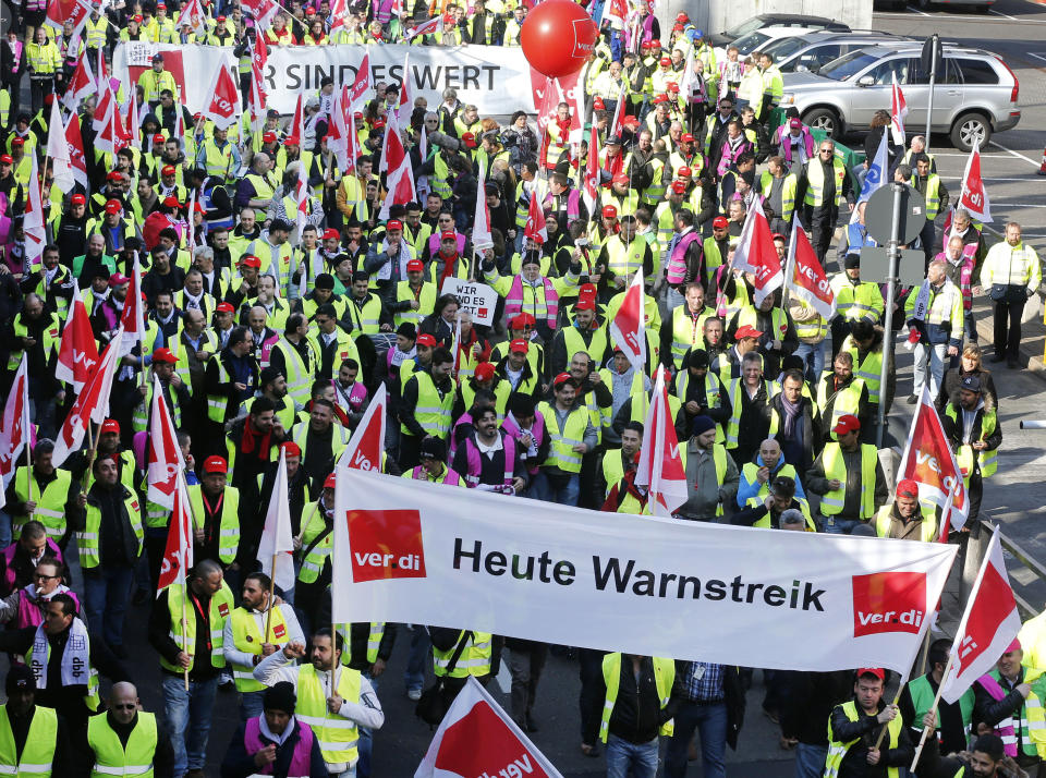 Public-sector employees of the Frankfurt airport gather for a warning strike, demanding higher wages in Frankfurt, Germany, Thursday, March 27, 2014. Germany's largest airline Lufthansa alone said it was cancelling 600 flights Thursday, from primarily within Europe, as a result of the strike. (AP Photo/Michael Probst)