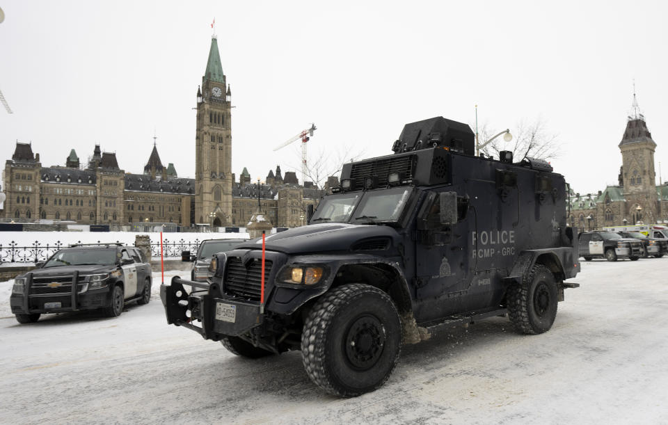 An RCMP tactical vehicle drives past the Parliament buildings, Sunday, Feb. 20, 2022 in Ottawa. (Adrian Wyld/The Canadian Press via AP)
