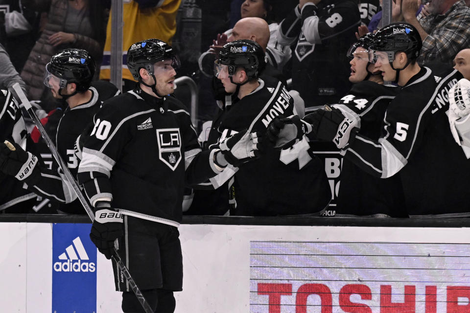 Los Angeles Kings center Pierre-Luc Dubois, second from left, is congratulated for his goal against the Calgary Flames during the first period of an NHL hockey game in Los Angeles, Saturday, Dec. 23, 2023. (AP Photo/Alex Gallardo)