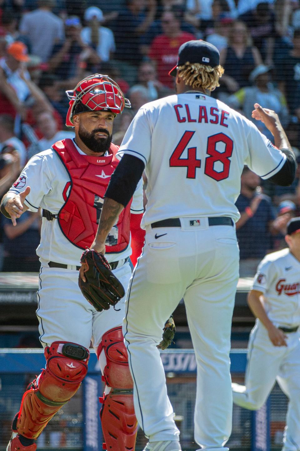 Guardians' catcher Sandy Leon congratulates Guardians closer Emmanuel Clase for preserving a 2-0 win over the New York Yankees on Sunday at Progressive Field. [Phil Long/Associated Press]