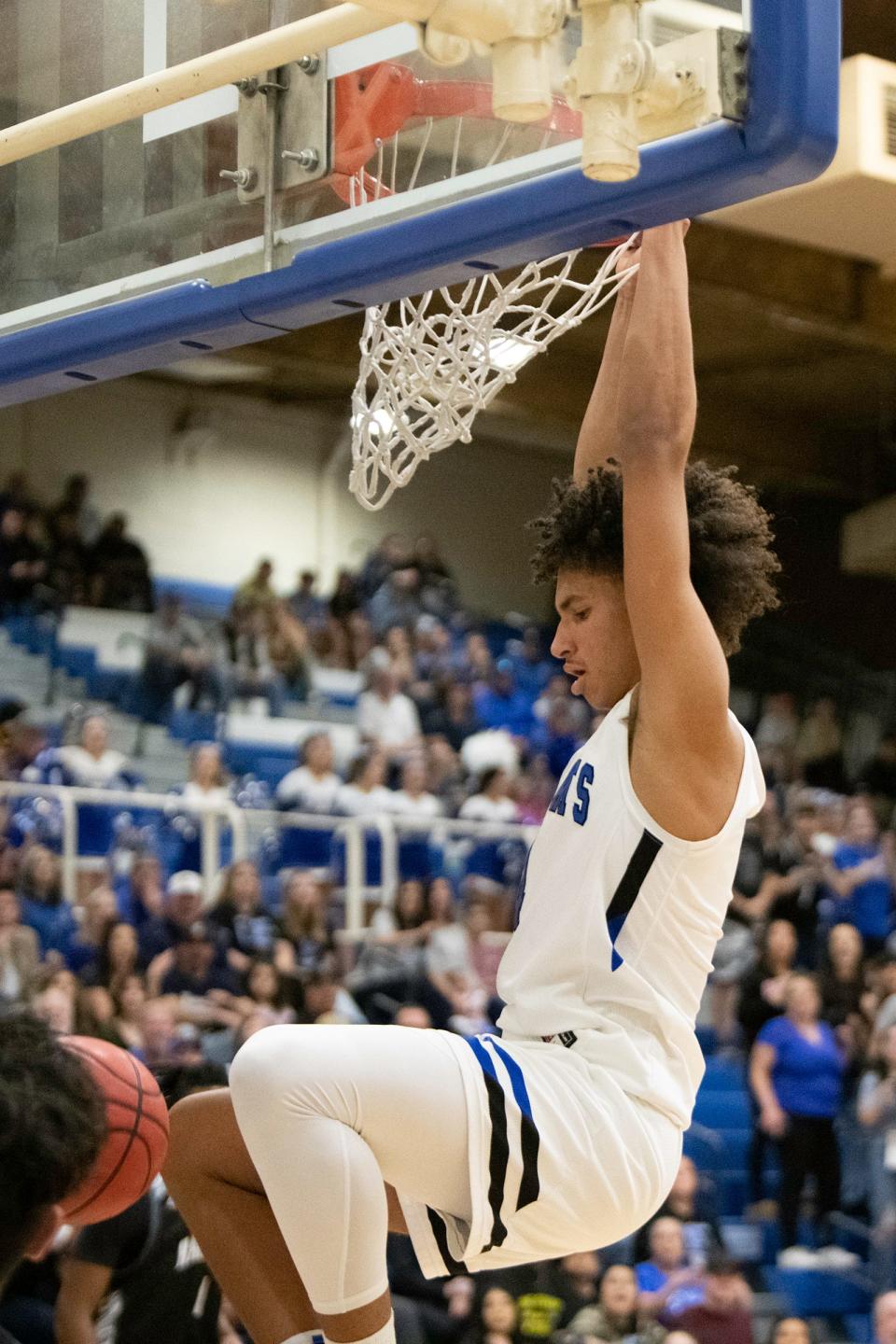 Pueblo Central's Kadyn Betts goes up high for a slam dunk during the third round of the Class 4A state tournament against Harrison at Jim Ranson Court on March 22.