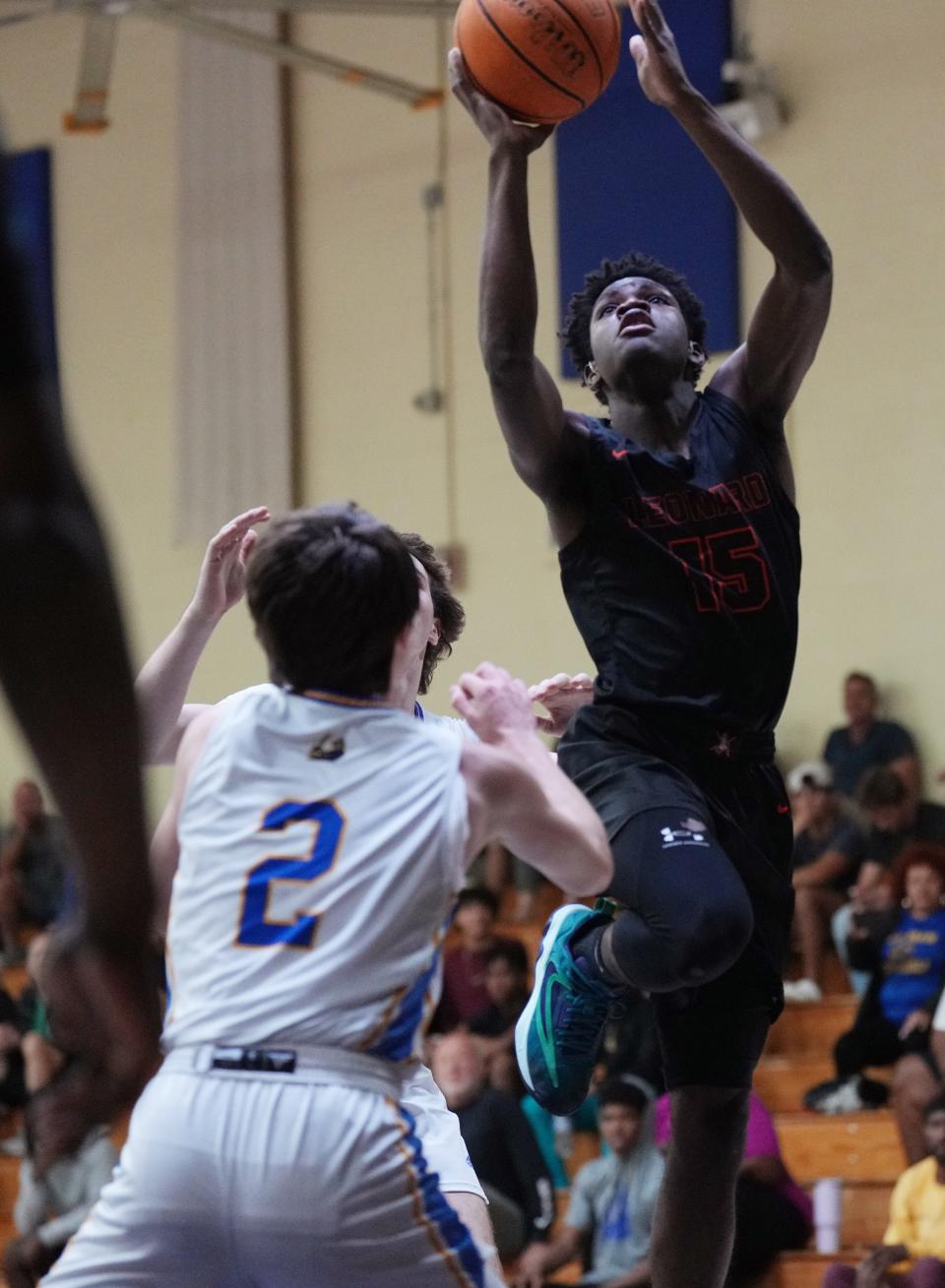 Lovinske Louis, #15, of the John I. Leonard basketball team, goes up for a shot against Cardinal Newman. Louis plays with the help of an interpreter to help him with his hearing disability. Friday, January 12, 2024 in West Palm Beach.