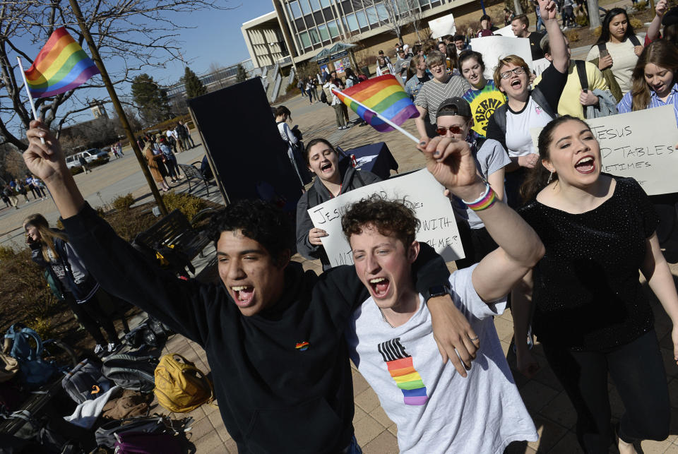 FILE - Lorenzo Larios, left, and Danny Niemann chant "gay rights" as they join a student protest outside the student center at Brigham Young University in Provo, Utah on March 4, 2020. The U.S. Department of Education has opened a civil-rights investigation into how LGBTQ students are disciplined at Brigham Young University, a private religious school. The complaint under investigation came after the school said it would still enforce a ban on same-sex dating even after that section was removed from the written version of the school's honor code, the Salt Lake Tribune reported. (Francisco Kjolseth/The Salt Lake Tribune via AP, File)