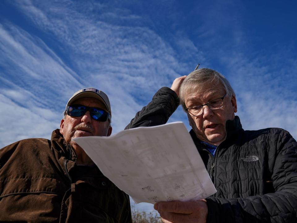 Carroll Midgett Sr. and Gus Gusler discuss moving his house away from the rapidly eroding coastline on North Carolina’s Outer Banks in January 2023.