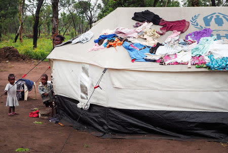 Children stand beside tents a refugee camp in Lovua, Angola, September 13, 2017. REUTERS/Stephen Eisenhammer