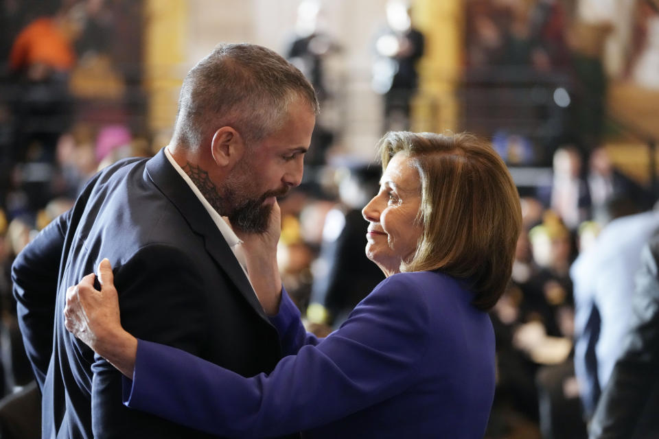 Speaker of the House Nancy Pelosi of Calif., embraces former Washington Metropolitan Police Department officer Michael Fanone before the start of a Congressional Gold Medal ceremony honoring law enforcement officers who defended the U.S. Capitol on Jan. 6, 2021, in the U.S. Capitol Rotunda in Washington, Tuesday, Dec. 6, 2022. (AP Photo/Alex Brandon)