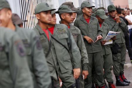 Soldiers stand in line outside a polling station to cast their vote during a legislative election, in Caracas December 6, 2015. REUTERS/Carlos Garcia Rawlins