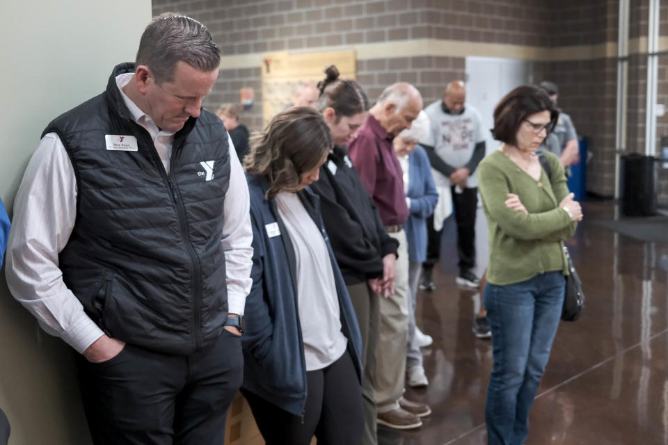Attendees pray during the recent dedication ceremony for a new prayer wall at the Earlywine Park YMCA in Oklahoma City.