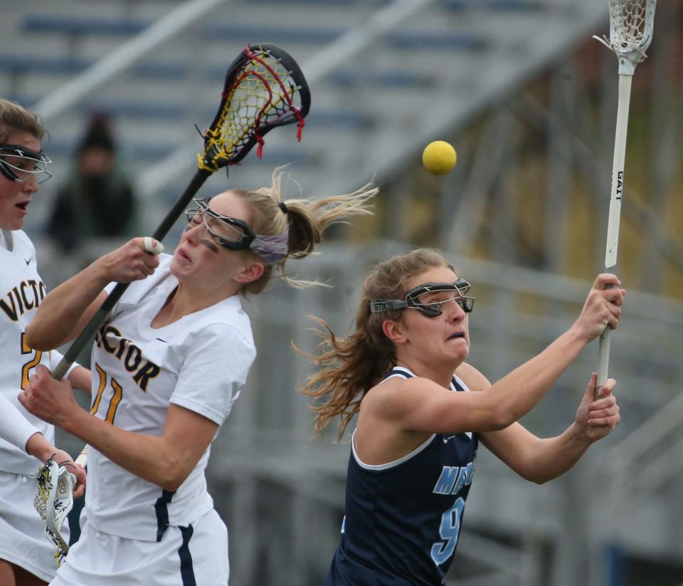 Mercy's Maddie Fitzgerald knocks the ball away from Victor's Devin Livingston.