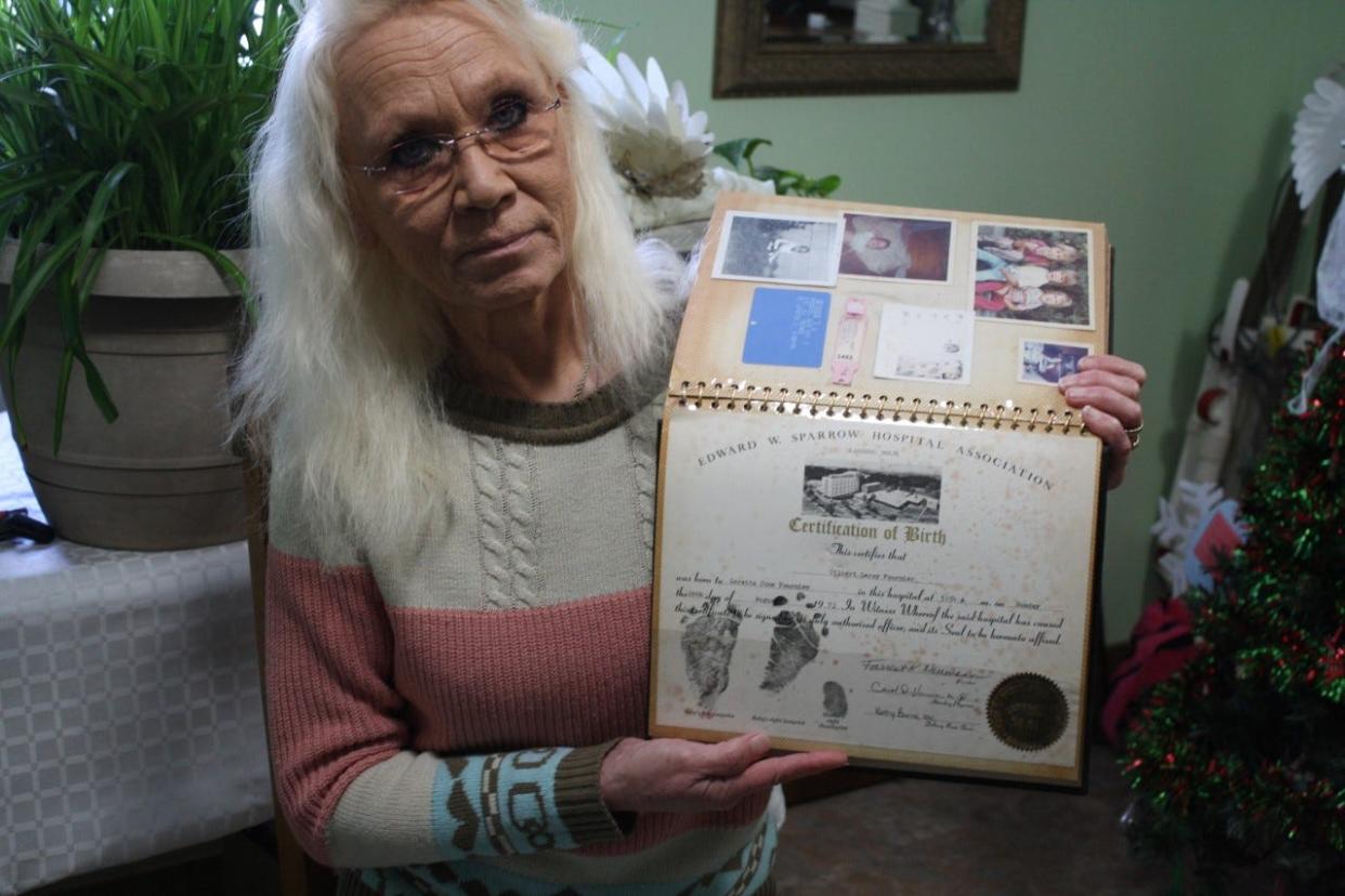 Elizabeth Michalski holds up the birth certificate for her brother Gilbert Leroy Fournier. He was born in 1973 at Sparrow Hospital in Lansing. Michalski met him once when he was two years old. Finding him represented the last piece in the puzzle that is her family, she said.