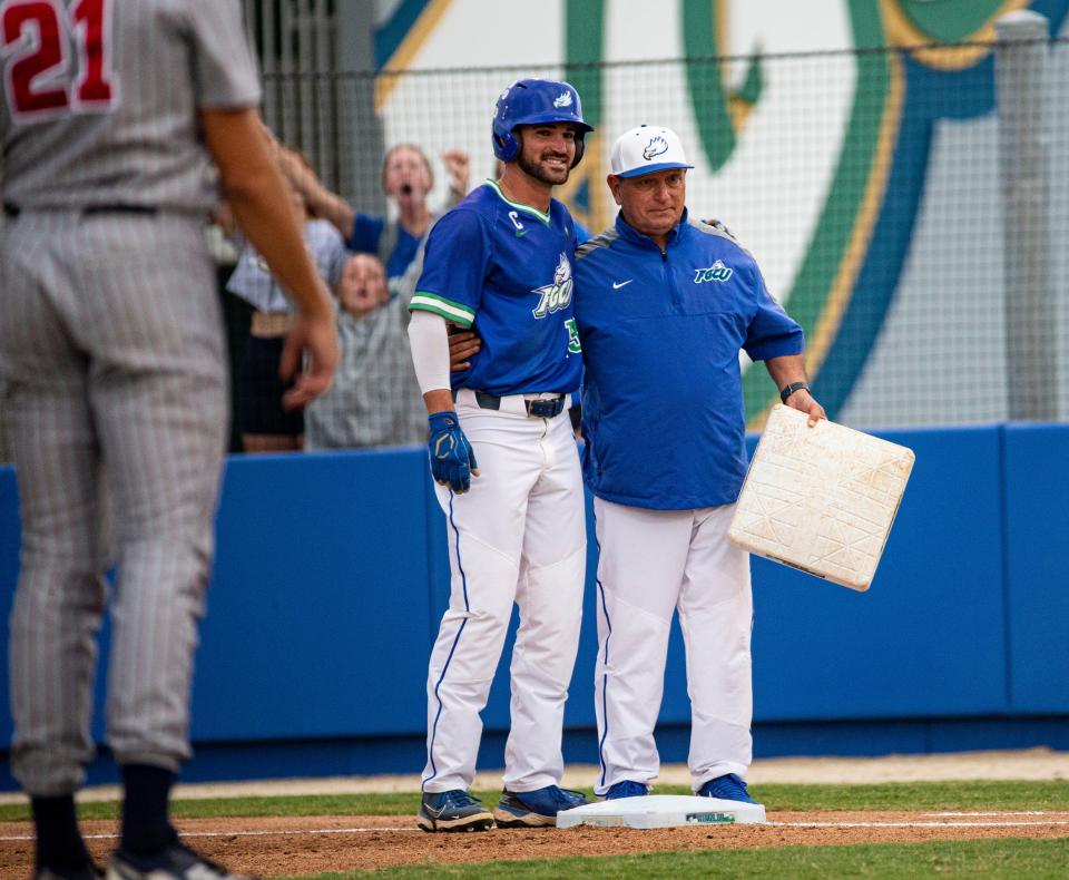 Brian Ellis, an outfielder for the Florida Gulf Coast University baseball team is congratulated by head coach Dave Tollett during a game against FAU at FGCU on Tuesday, April 11, 2023. He broke the NCAA record for most consecutive times for reaching base at 102 games.