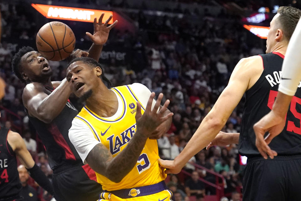 Los Angeles Lakers forward Cam Reddish (5) is fouled by Miami Heat center Thomas Bryant, left, during the first half of an NBA basketball game, Monday, Nov. 6, 2023, in Miami. (AP Photo/Lynne Sladky)