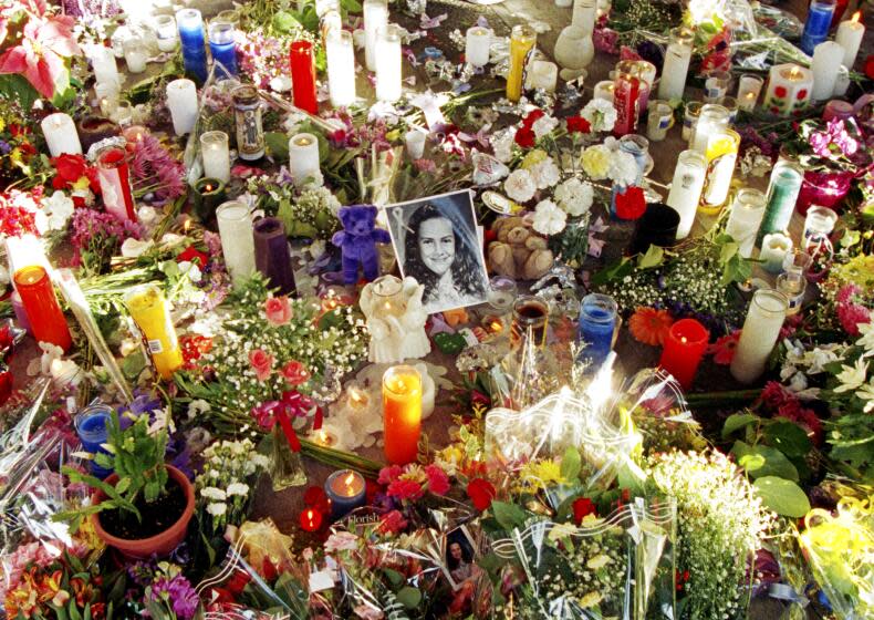 Flowers and candles surround a photo of 12-year-old Polly Klass in Petaluma, California, December 5, 1993 the day her body was found. On October 1, 1993, she was kidnapped at knife point during a slumber party at her mother's home and was later strangled. (NewsBase / AP)