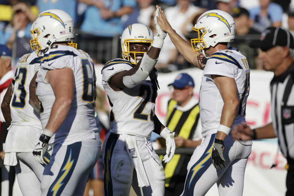 Los Angeles Chargers running back Melvin Gordon (25) is congratulated by quarterback Philip Rivers, right, after Gordon scored a touchdown against the Tennessee Titans in the first half of an NFL football game Sunday, Oct. 20, 2019, in Nashville, Tenn. (AP Photo/James Kenney)