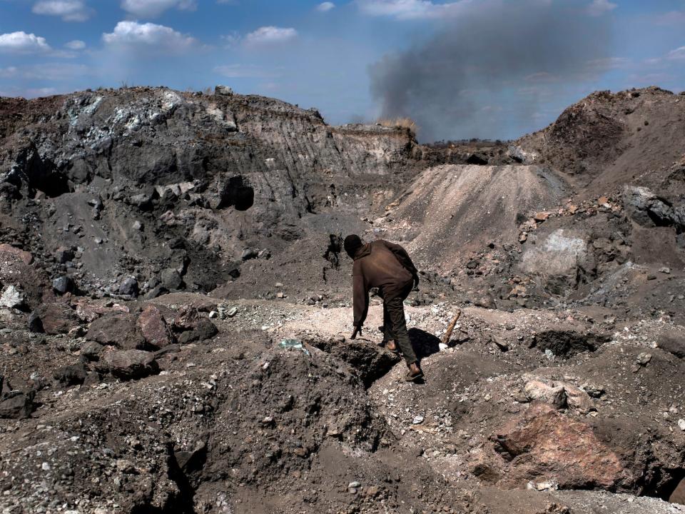 A digger climbs through a copper and cobalt mine in Kawama, Democratic Republic of Congo