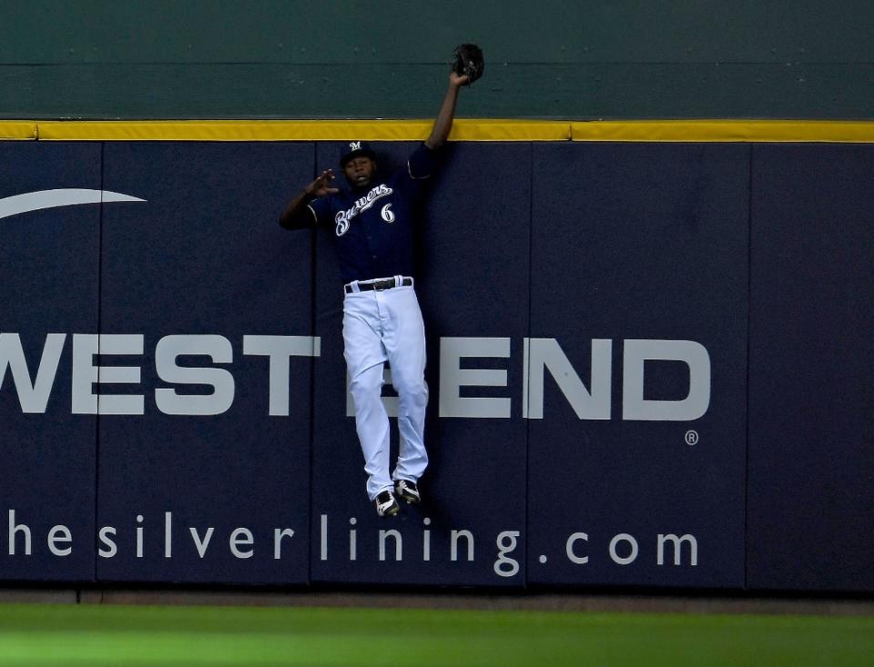 Brewers center fielder Lorenzo Cain takes a homer away from the Dodgers' David Freese in NLCS Game 2. (AP)