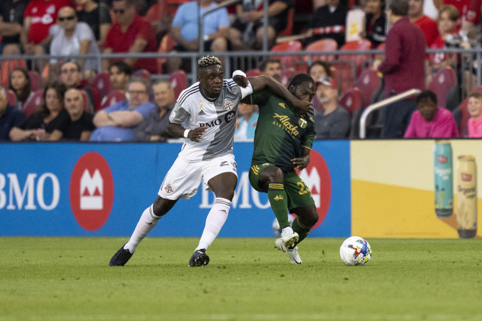 Toronto FC defender Chris Mavinga (23) vies for the ball against Portland Timbers forward Yimmi Chará (23) during the first half of an MLS soccer match in Toronto on Saturday, Aug. 13, 2022. (Andrew Lahodynskyj/The Canadian Press via AP)