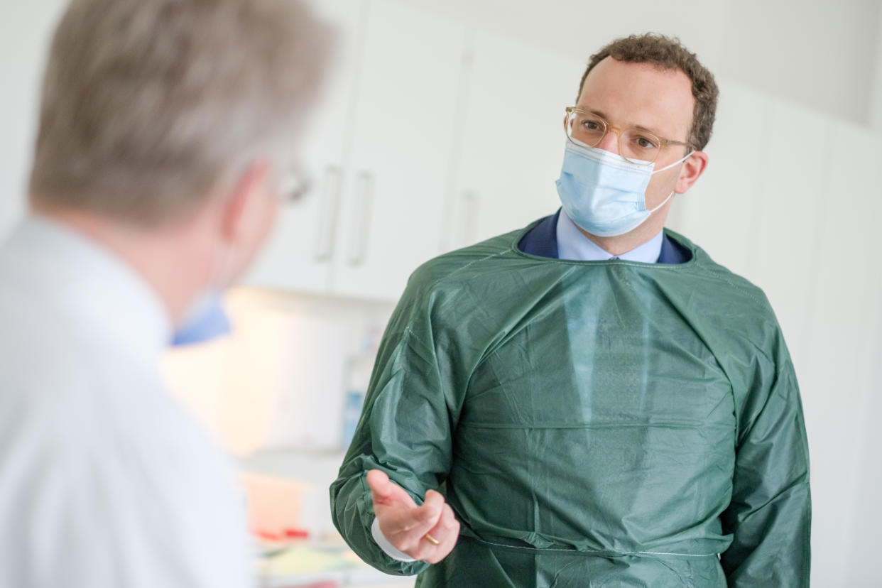 German Health Minister Jens Spahn (R) wears a face mask as he speaks with Christoph Schindler, clinical researcher at the Clinicial Research Center (CRC) of the Medizinische Hochschule Hannover (MHH) medical university, during a visit at the centre's department for research on primary vaccination, on April 28, 2020 in Hanover, northern Germany. (Photo by Ole Spata / POOL / AFP) (Photo by OLE SPATA/POOL/AFP via Getty Images)