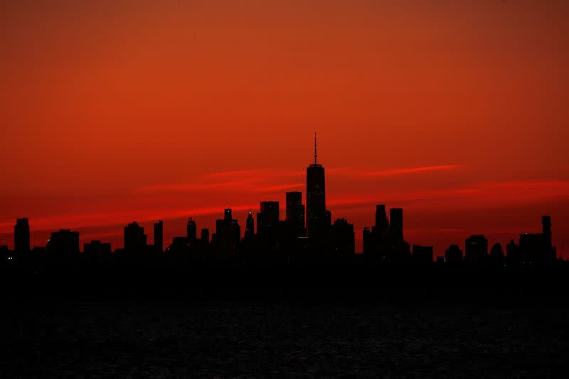 One World Trade Center and the lower Manhattan skyline are seen shortly after sunset from the Rockaway section of Queens, New York