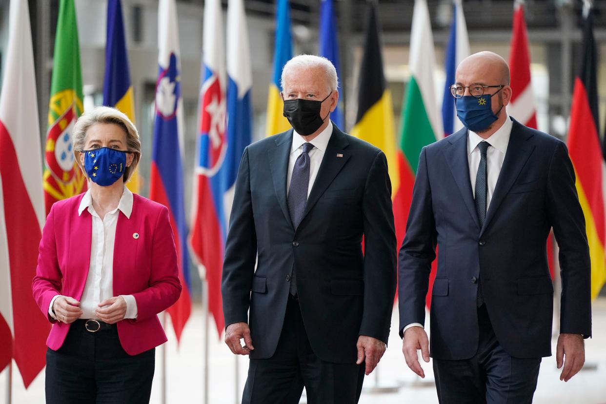 President Joe Biden (center) walks with European Council President Charles Michel (right) and European Commission President Ursula von der Leyen (left) 