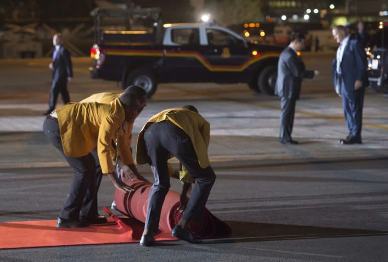 Workers roll out a red carpet as US President Barack Obama arrives on Air Force One at Kenyatta International Airport in Nairobi, Kenya, July 24, 2015