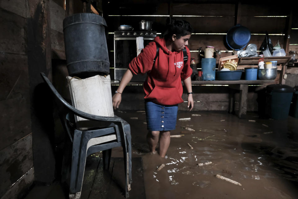 A woman walks into her house, flooded during the passage of Hurricane Iota in Siuna, Nicaragua, Tuesday, Nov. 17, 2020. Hurricane Iota tore across Nicaragua on Tuesday, hours after roaring ashore as a Category 4 storm along almost exactly the same stretch of the Caribbean coast that was recently devastated by an equally powerful hurricane. (AP Photo/Carlos Herrera)