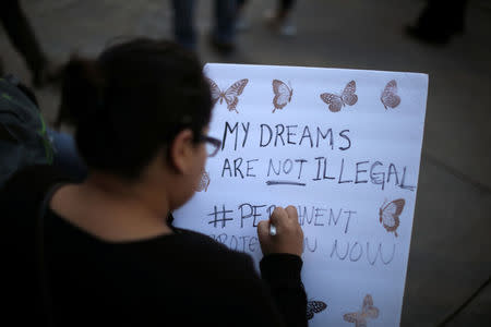 FILE PHOTO: A woman protests to call for a new DREAM Act to replace DACA in Los Angeles, California U.S. January 17, 2018. REUTERS/Lucy Nicholson